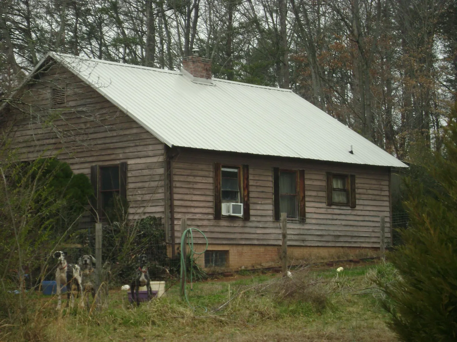 White metal roof on an old wood sided farmhouse, from a Metal Roof Installation job in Cayce